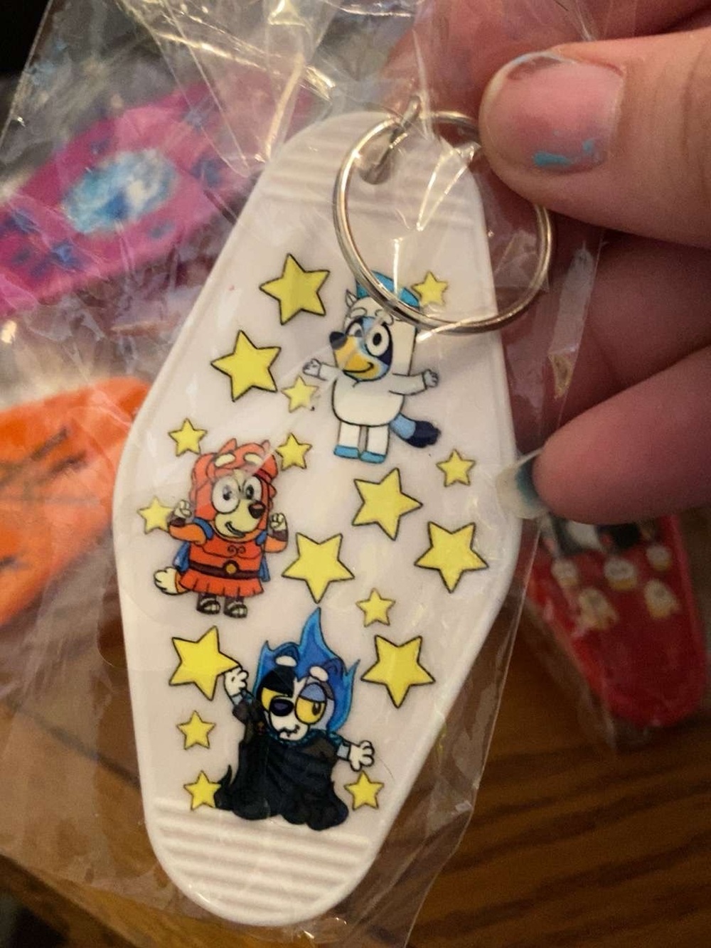 White Cartoon Character Keychain with Yellow Stars